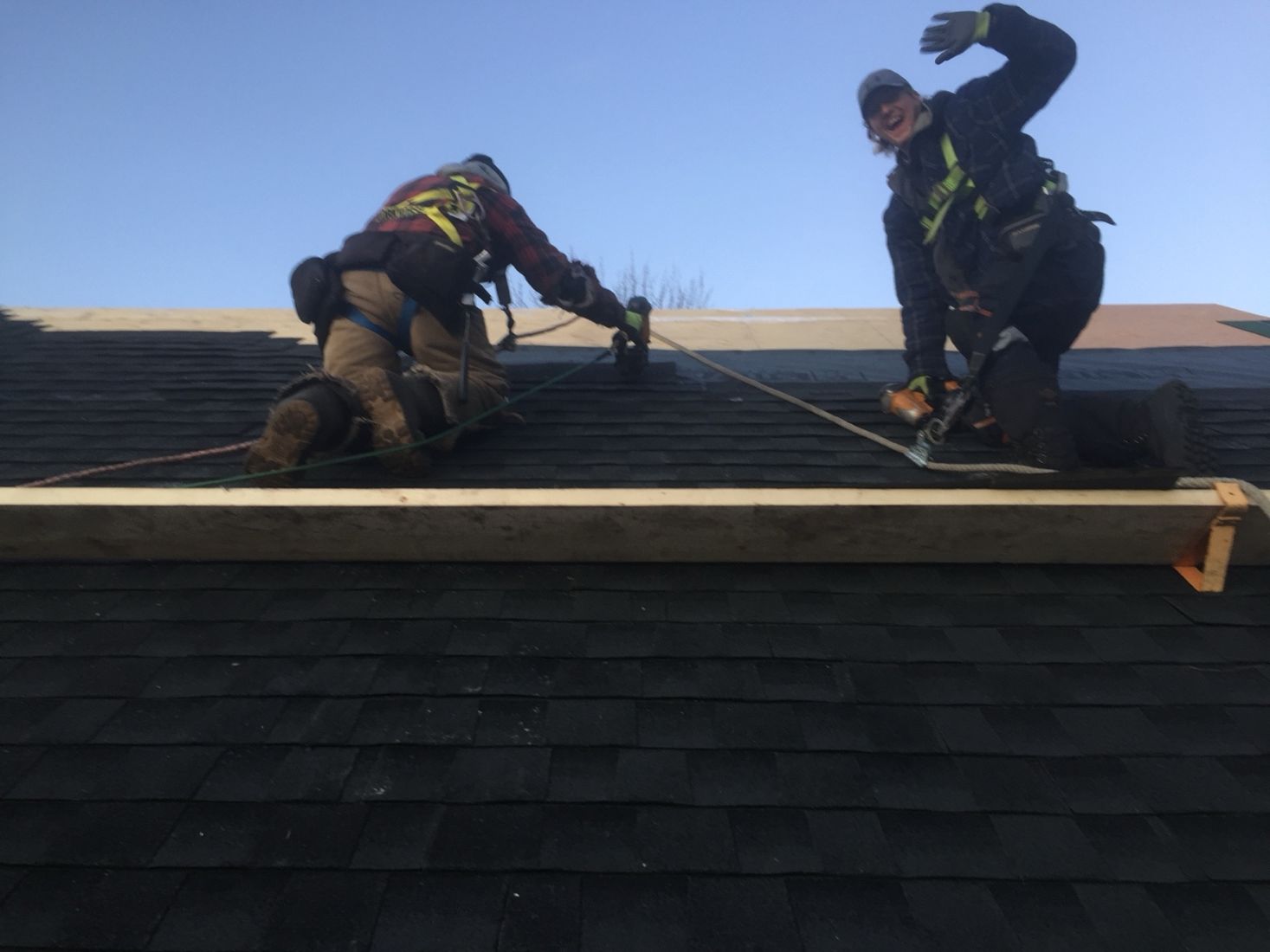Roofers working on a shingle installation